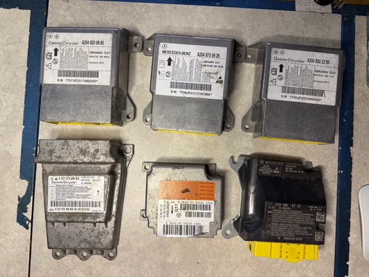 Mercedes-Benz and DaimlerChrysler SRS airbag modules with W204, W210, W221, W222 part number labels reset on the ECU Team bench, West Palm Beach FL