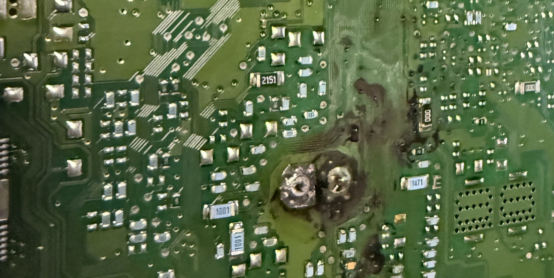 Burned circuit board inside a Genesis 4.6 engine control module, West Palm Beach electronic laboratory.
