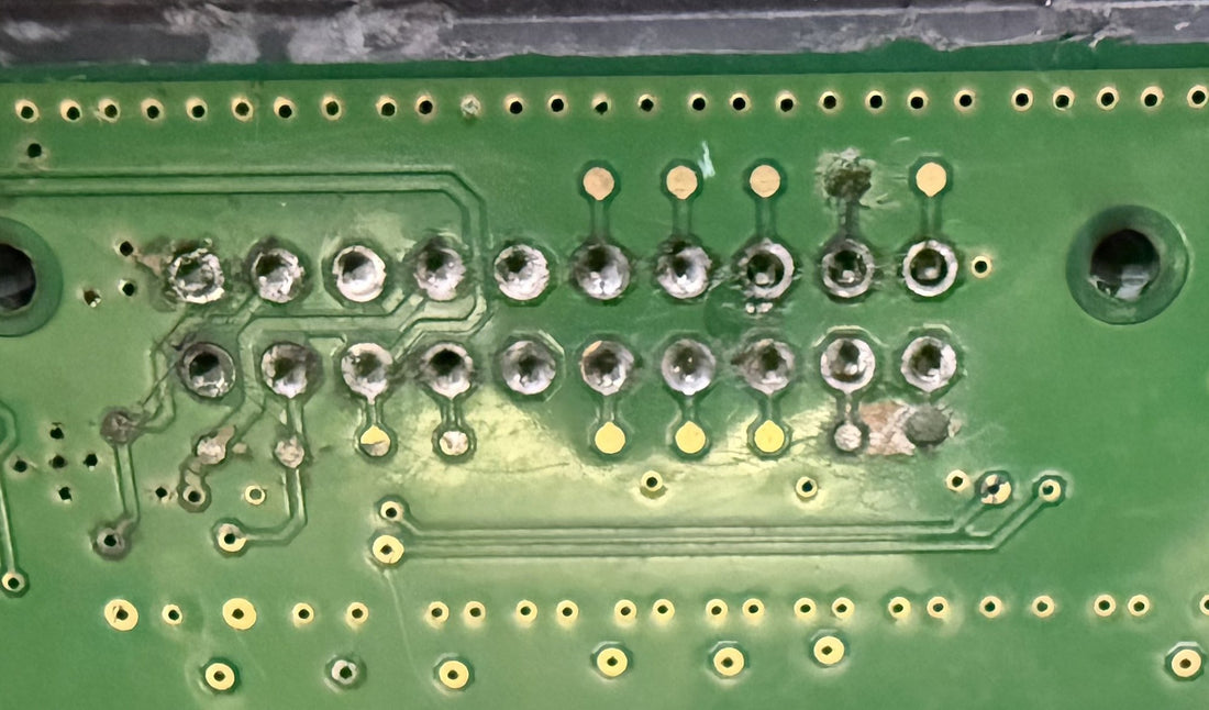 Water damage and corrosion on the contact pads inside a VW Passat gateway module, West Palm Beach electronic laboratory.