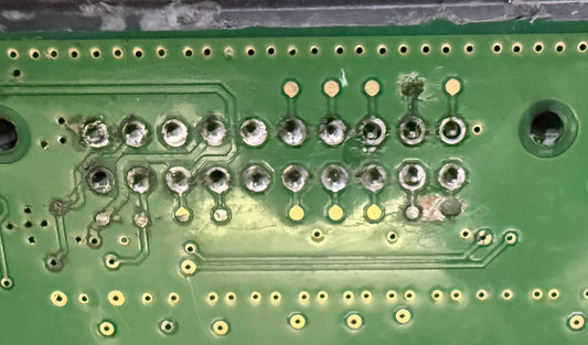 Water damage and corrosion on the contact pads inside a VW Passat gateway module, West Palm Beach electronic laboratory.